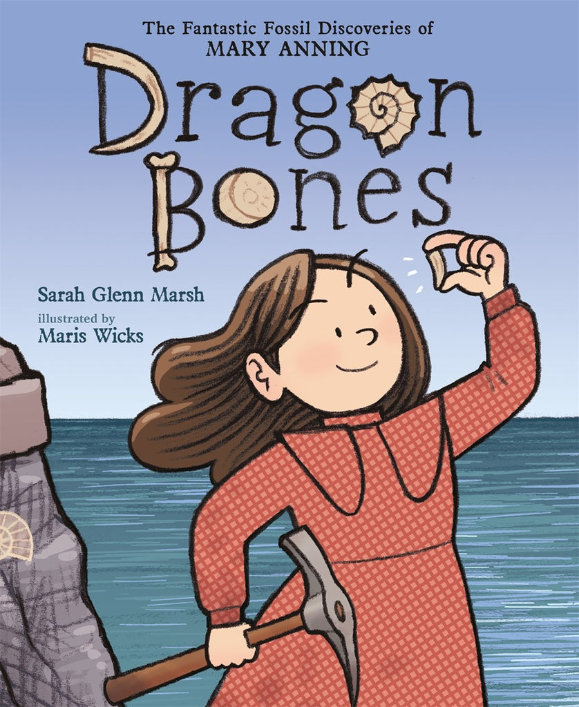 Mary Anning, a white girl wearing a red dress, stands in triumph holding a dinosaur tooth and a pickaxe against an ocean backdrop. Text: Dragon Bones