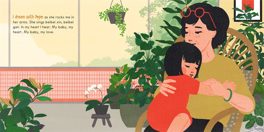 A little girl sits on her grandmother's lap in a room filled with plants